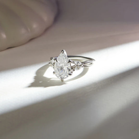 Pear Shaped Solitaire Ring with Marquise Diamond Accents